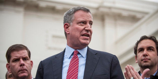 New York Mayor-elect Bill de Blasio, center, speaks during a news conference with a group of newly-elected mayors from across the country at the White House in Washington, D.C., U.S., on Friday, Dec. 13, 2013. de Blasio said the nation's mayors can be crucial allies for President Barack Obama in addressing income inequality in the U.S. Photographer: Pete Marovich/Bloomberg via Getty Images 