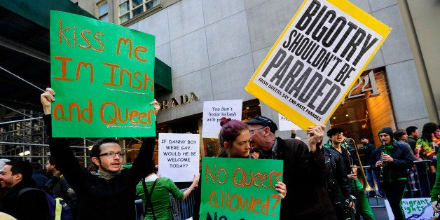 A handful of gay activist display signs along St Patrick's Day parade in protest for being excluded from the annual parade on Fifth Avenue in New York, March 17, 2011. Irish gayshave been battling unsuccessfully for two decades to be allowed to join the parade as an official contingent. Their annual protest along the Fifth Avenue route has become almost part of the parade's fabric. AFP PHOTO/Emmanuel Dunand (Photo credit should read EMMANUEL DUNAND/AFP/Getty Images)