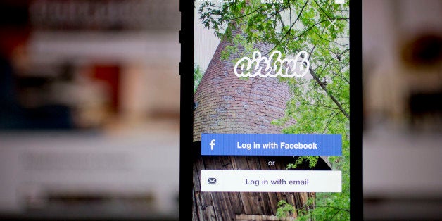 The Airbnb Inc. application and website are displayed on an Apple Inc. iPhone and iPad in this arranged photograph in Washington, D.C., U.S., on Friday, March 21, 2014. Airbnb Inc. is raising money from investors including TPG Capital in a financing round that would value the room-sharing service at more than $10 billion, said people with knowledge of the deal. Photographer: Andrew Harrer/Bloomberg via Getty Images