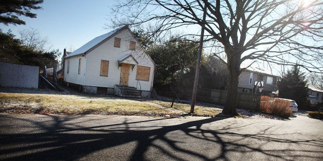 ISLIP, NY - FEBRUARY 09: A foreclosed home stands boarded up on February 9, 2012 in Islip, New York. A New York State Department of Financial Services Foreclosure Relief Unit van visited Islip to provide individuals who are facing foreclosure with counselors who can assess where homeowners are in the pre-foreclosure or foreclosure process. The mobile unit, which is eequipped with computers and communications, looks to slow the number of foreclosures in the state and to provide information about loan modifications available to homeowners under federal law. Islip, which is located in Suffolk County, has the highest foreclosure rate in New York State. (Photo by Spencer Platt/Getty Images)