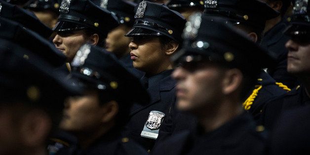 NEW YORK, NY - JULY 02: New York City Police Academy cadets attend their graduation ceremony at the Barclays Center on July 2, 2013 in the Brooklyn borough of New York City. The New York Police Department (NYPD) has more than 37,000 officers; 781 cadets graduated today. (Photo by Andrew Burton/Getty Images)
