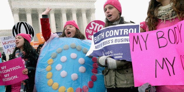 WASHINGTON, DC - MARCH 25: Demonstrators rally outside of the U.S. Supreme Court during oral arguments in Sebelius v. Hobby Lobby March 25, 2014 in Washington, DC. The court heard from lawyers on both sides of Sebelius v. Hobby Lobby, a case that may determine whether the Religious Freedom Restoration Act of 1993 allows a for-profit corporation to deny its employees the health coverage of contraceptives to which the employees are otherwise entitled by federal law, based on the religious objections of the corporation's owners. (Photo by Chip Somodevilla/Getty Images)