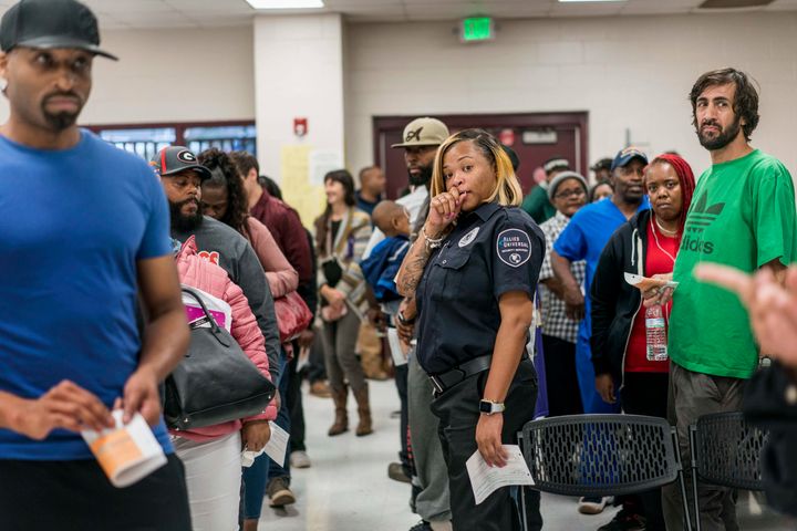 People stand in line to vote at the Pittman Park Recreation Center polling location in Atlanta. A limited number of voting machines created huge wait times at several Georgia polling sites.
