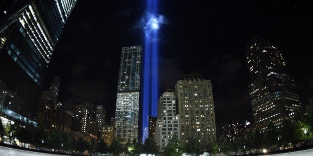 The Tribute in Light illuminates the sky behind the 9/11 Memorial waterfalls and reflecting pool in New York on September 1