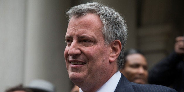 NEW YORK, NY - SEPTEMBER 16: New York City Democratic mayoral candidate Bill De Blasio, speaks outside New York City Hall after mayoral hopefull Bill Thompson (not seen) conceded the Democratic party candidate position to De Blasio on September 16, 2013 in New York City. Thompson and De Blasio both hoped to win the democratic cadidate position for New York City. While De Blasio had a majority lead in the primary vote with approximately 40% of the votes, Thompson had hoped that he could force a run off between the two. New York Governor Andrew Cuomo (L) also attended the speech. (Photo by Andrew Burton/Getty Images)