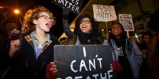 LONDON, UNITED KINGDOM - DECEMBER 10: Hundreds of people demonstrate outside White City Westfield Shopping Centre in London, England on December 10, 2014 during a protest after two grand juries decided not to indict the police officers involved in the deaths of Michael Brown in Ferguson, Mo. and Eric Garner in New York, N.Y. (Photo by Tolga Akmen/Anadolu Agency/Getty Images)