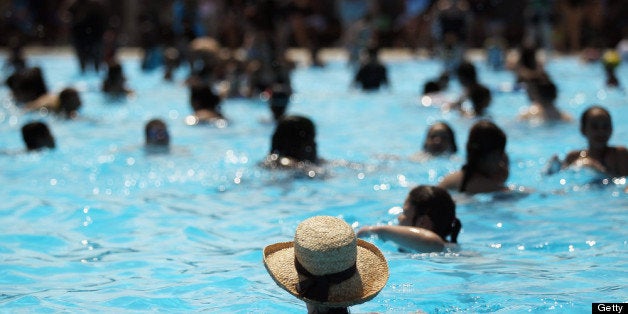 NEW YORK, NY - JUNE 28: People bathe on opening day of the newly renovated McCarren Park Pool on June 28, 2012 in the Brooklyn borough of New York City. The historic 37,000 square-foot pool had been closed since 1983 but has been rejuvenated by a $50 million restoration. Today is the first day New York City public pools opened for the summer. (Photo by Mario Tama/Getty Images)