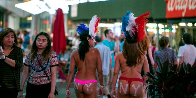 Costumed women walk through Times Square, Wednesday, Sept. 2, 2015, in New York. Concerned that Times Square is becoming less wholesome, the New York Police Department is assigning plainclothes officers to discourage aggressive panhandling in the tourist mecca that long ago rid itself of hookers and junkies. (AP Photo/Craig Ruttle)