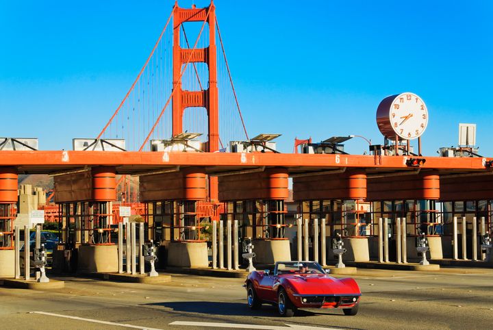 Lone car going through Golden Gate Bridge toll booth