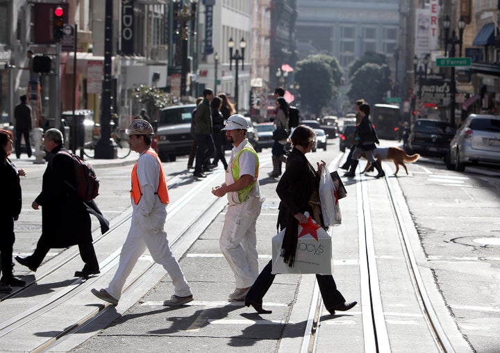 SAN FRANCISCO, CA - JANUARY 14: A pedestrian carries a shopping bag while walking through Union Square on January 14, 2011 i