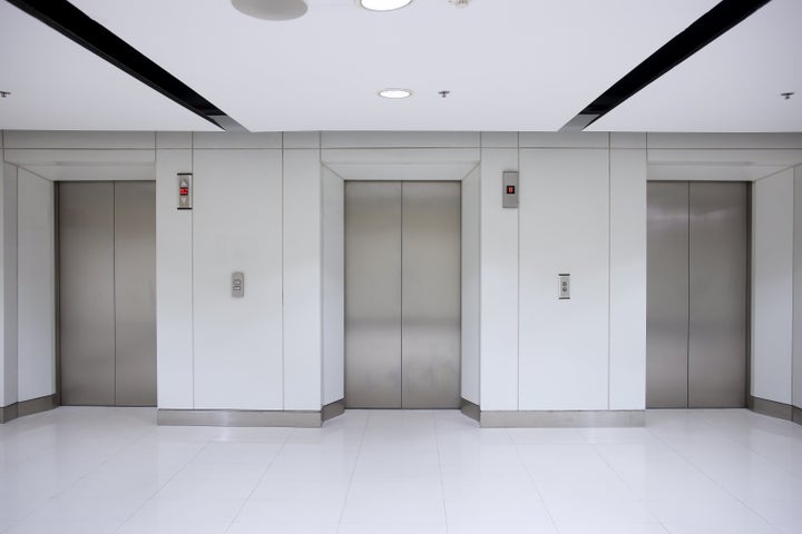 three elevator doors in office...
