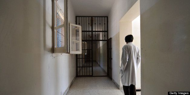 A metal-barred doors stands open in a hall of the Psychiatric hospital in Tripoli, on August 28, 2011. Tripoli's sole psychiatric hospital, already unable to cope under Libyan leader Moamer Kadhafi, is struggling with a flood of new cases brought on by the revolution's battles, as well as a lack of drugs, staff and space. The hospital covers all of western Libya: a population of around three million people spread out over millions of square miles (kilometres). AFP PHOTO / Charles ONIANS (Photo credit should read CHARLES ONIANS/AFP/Getty Images)