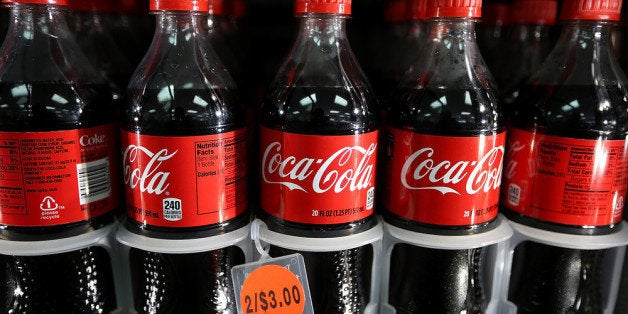 SAN FRANCISCO, CA - MARCH 25: Bottles of Coca Cola sit in a cooler at a 76 gas station on March 25, 2013 in San Francisco, California. According to a report by Beverage Digest, sales of carbonated soft drinks in the United States fell 1.2 percent in 2012 to 9.17 billion cases. (Photo by Justin Sullivan/Getty Images)