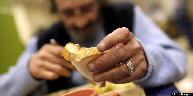 SAN FRANCISCO - SEPTEMBER 16: A man named R.J. holds a piece of bread as he eats a free meal provided by St. Anthony foundation on September 16, 2010 in San Francisco, California. The U.S. poverty rate increased to a 14.3 percent in 2009, the highest level since 1994. St. Anthony Foundation serves an average of 2,600 meals a day to homeless and impoverished people in San Francisco. (Photo by Justin Sullivan/Getty Images)