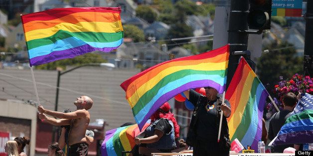 SAN FRANCISCO, CA - JUNE 26: Same-sex marriage supporters wave pride flags on the corner of Market and Castro on June 26, 2013 in San Francisco, California. The Supreme Court of the United States struck down the Defense of Marriage Act (DOMA) and ruled that supporters of California's ban on gay marriage, Proposition 8, could not defend it before the Supreme Court. (Photo by Justin Sullivan/Getty Images)
