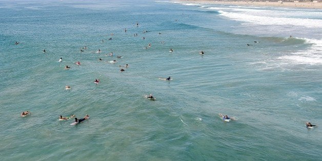 Surfers wait for the right wave to catch at Huntington Beach in California on September 10, 2015, amid a heat wave where temperatures have reached triple digits in parts of southern California. The current El Nino phenomenon, a global weather pattern known to wreak havoc every few years, should last until spring and likely become one of the strongest on record, forecasters said. AFP PHOTO / FREDERIC J.BROWN (Photo credit should read FREDERIC J. BROWN/AFP/Getty Images)