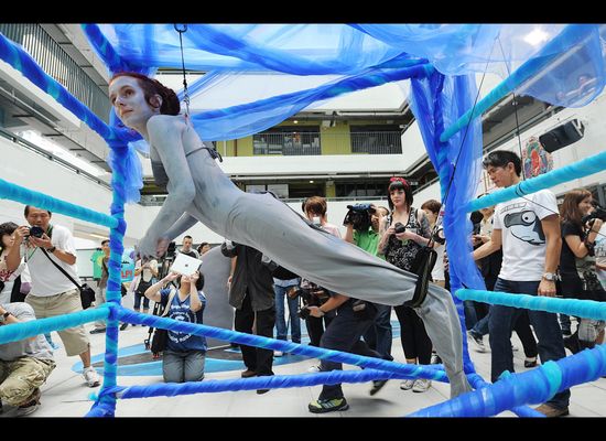 Artist hangs herself from hooks in protest at shark treatment