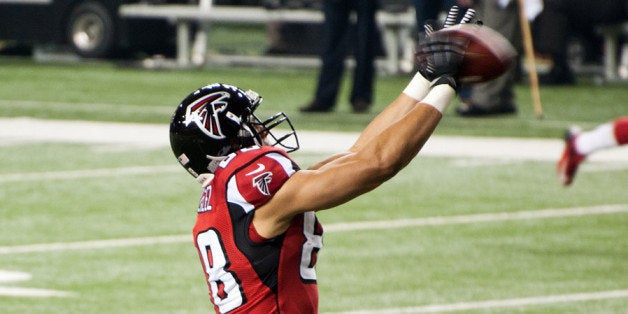 Atlanta Falcons tight end Tony Gonzalez reels in a catch duing pregame warmups during the Falcons game against the Dallas Cow