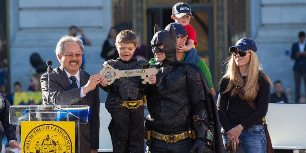 SAN FRANCISCO, CA - NOVEMBER 15: Batkid Miles Scott receives a key to the city with Mayor Ed Lee, his mother Natalie Scott and his father Nick Scott at San Francisco City Hall on November 15, 2013 in San Francisco, California. (Photo by Miikka Skaffari/Getty Images)