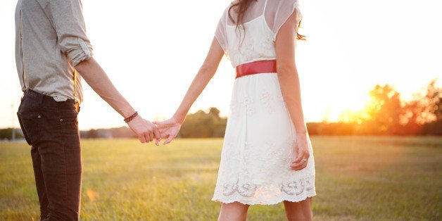 couple holding hands walking...