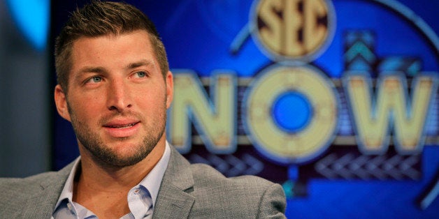 Tim Tebow ponders a question during an interview on the set of ESPN's new SEC Network in Charlotte, N.C., Wednesday, Aug. 6,