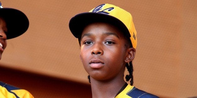 CHICAGO - AUGUST 27: Jackie Robinson West little league baseball player Jaheim Benton acknowledges the crowd during the team's United States World Series Championship Rally at Millennium Park on August 27, 2014 in Chicago, Illinois. (Photo By Raymond Boyd/Getty Images)