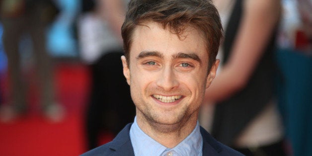 FILE - In this file photo taken Tuesday, Aug. 12, 2014, British actor Daniel Radcliffe reacts, as he arrives on the red carpet for the UK premiere of What If, at the Odeon West End in central London. aniel Radcliffe says he finds the concept of celebrity and the level of interest in the trivia of actorsâ lives âweird.â While promoting his first romantic comedy _ âWhat If,â directed by Michael Dowse _the 25-year-old British star was keen to keep the conversation away from his own love life. Radcliffe is rumored to be dating his âKill your Darlingsâ co-star Erin Drake. (Photo by Joel Ryan/Invision/AP)