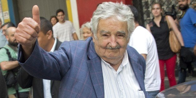 Uruguay's President Jose Mujica gives the thumb up as he leaves after delivering a press conference to present a US' Department of State document with information about the former Guantamano prisoners who recently arrived in Uruguay, on December 16, 2014. According to the document, 'there is no information that (the six former inmates) were involved in conducting or faciliting terrorist activities against the United States or its partners or allies'. AFP PHOTO / PABLO PORCIUNCULA (Photo credit should read PABLO PORCIUNCULA/AFP/Getty Images)