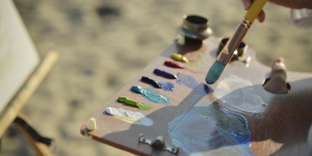 Woman drawing the oil painting on the beach