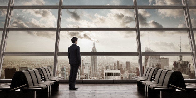 Man standing infronf of windows