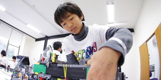 SYDNEY, AUSTRALIA - JULY 05: A child from Japan operates his robot at the LEGO Education FIRST Robot Games Tournament on July 5, 2013 in Sydney, Australia. Over 50 teams, 550 children from 15 countries traveled to Sydney, Australia for the Asia-Pacific Open FIRST Lego League Championships. The FIRST program is designed to inspire children to pursue opportunities in science, engineering and technology and become the IT entrepreneurs of the future. Teams from Australia, Brazil, China, Hong Kong, Egypt, India, Japan, Philippines, Romania, Saudi Arabia, Singapore, South Korea, Taiwan and Thailand came together to showcase their robot building skills and competed in tournaments for the prestigious FIRST Awards. (Photo by Brendon Thorne/Getty Images for LEGO Education/FIRST)