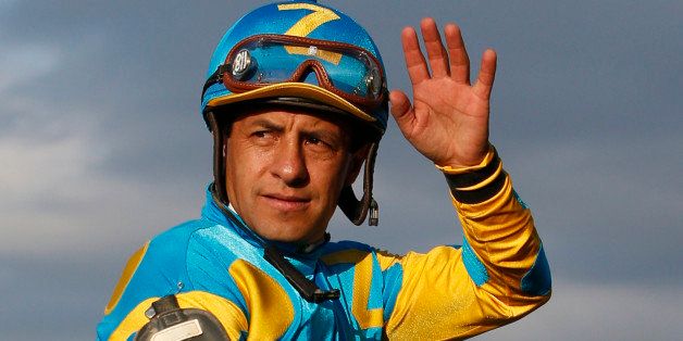 Victor Espinoza waves as he rides atop American Pharoah after winning the 147th running of the Belmont Stakes horse race at Belmont Park, Saturday, June 6, 2015, in Elmont, N.Y. American Pharoah won the race to become the first horse to win the Triple Crown in 37 years.(AP Photo/Kathy Willens)