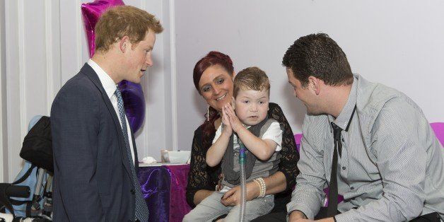 LONDON, ENGLAND - SEPTEMBER 22: Prince Harry meets Carson Hartley (4) who suffers from lung disease, heart defect, Spina bifida and brittle bone disease, with his mum Kirsty and dad Damian, during the WellChild awards at the London Hilton on September 22, 2014 in London, England. (Photo by Doug Seeburg-WPA Pool/Getty Images)