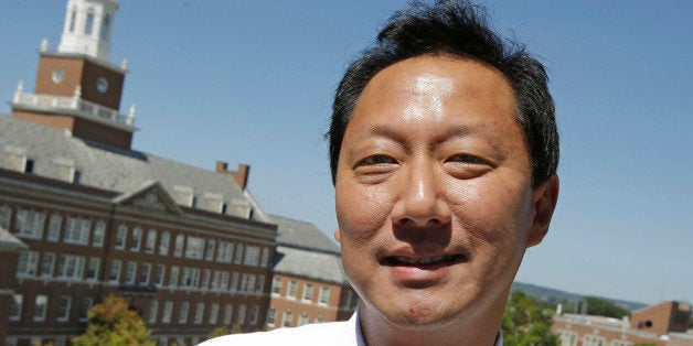 University of Cincinnati president Sana J. Ono poses on campus with McMicken Hall visible at left, Wednesday, Sept. 4, 2013, in Cincinnati. Now in his second year as president at the university, Ono interacts with students on a personal basis and thru social media. (AP Photo/Al Behrman)