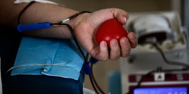 In this Tuesday, April 26, 2011 photo a man voluntary donates blood at the National Center for Hematology and Transfusion in Sofia. It's a grim reality for patients and families in Bulgaria, a struggling EU nation where donors are troublingly scarce, hospitals are strapped for funds and blood traders _ mainly Gypsy, or Roma, men _ are thriving. Trading in blood and blood products is illegal in Bulgaria, punishable by a fine of up to euro5,000 ($7,100). But lawyers say it's difficult to prove an illegal blood transaction because that requires an official complaint lodged by the person who pays the donor _ and families are so desperate they consider the black market blood donors lifesavers. (AP Photo/Valentina Petrova)