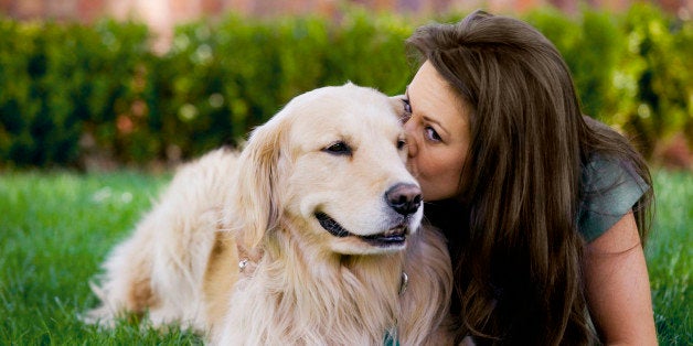 Woman kissing dog