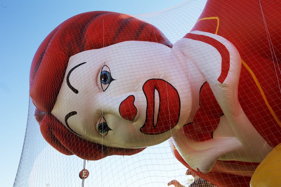 Ronald McDonald peers through the mesh that keeps him anchored. 