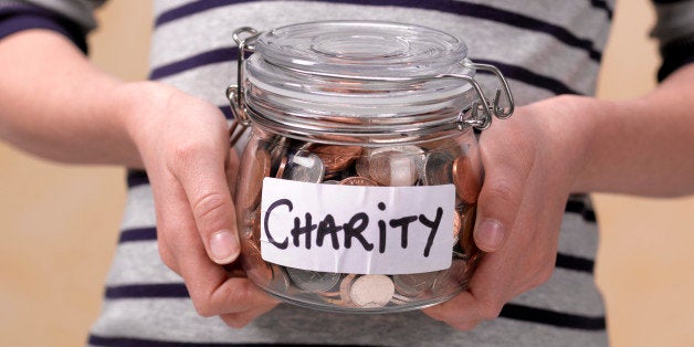 10 year old holding charity donations in a jar