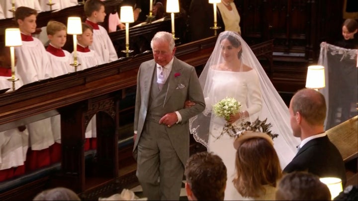 Meghan Markle walks down the aisle with Prince Charles for her wedding ceremony at St. George's Chapel in Windsor Castle in Windsor on May 19. 