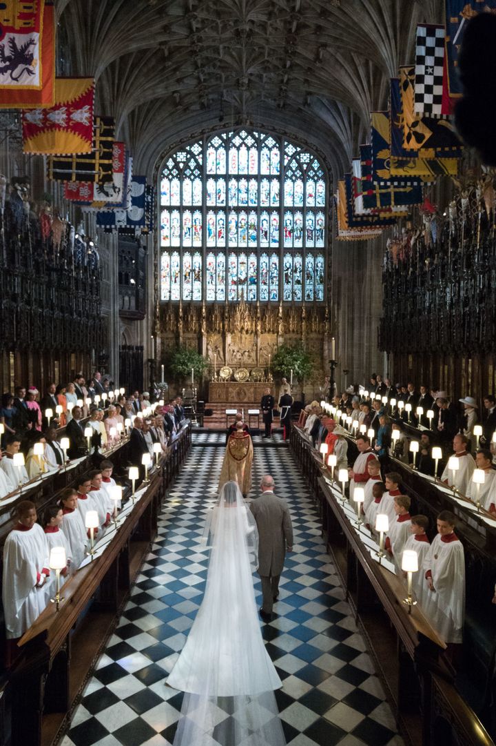 Meghan Markle and Prince Charles, Prince of Wales, walks down the aisle toward her husband-to-be, Britain's Prince Harry, Duke of Sussex, in St George's Chapel, Windsor Castle.