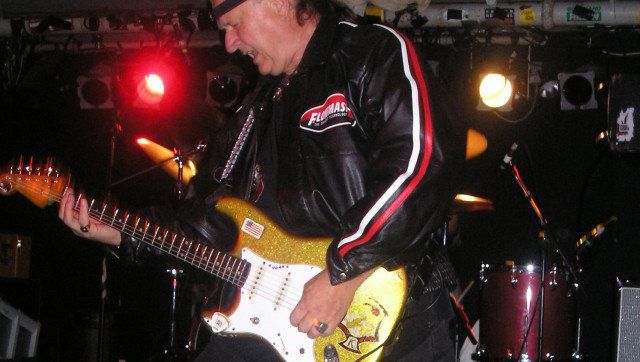 Description Guitarist en:Dick Dale | Dick Dale performing at the en:The Middle East (nightclub) | Middle East Restaurant and Nightclub in ... 