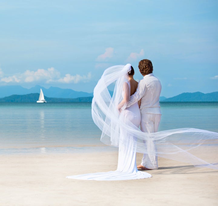 beautiful couple on the beach in wedding dress