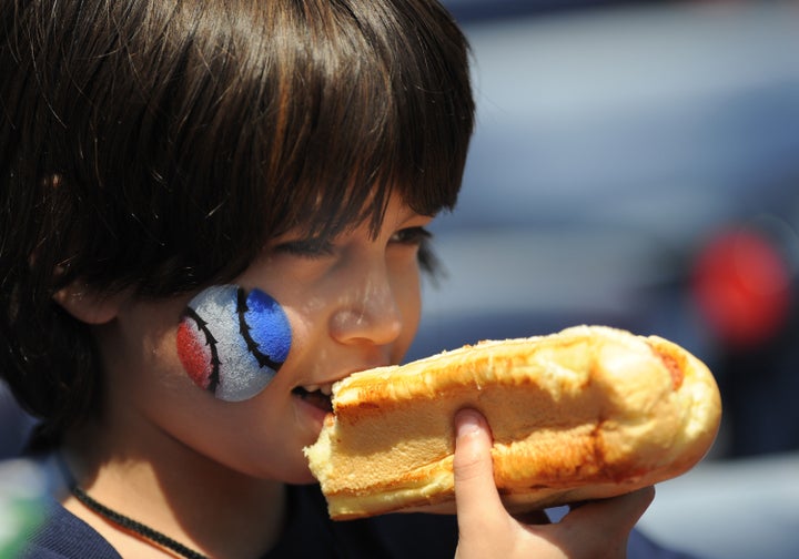 ATLANTA - APRIL 12: A young baseball fan enjoys a hot dog as the Atlanta Braves host the Washington Nationals April 12, 2009 at Turner Field in Atlanta, Georgia. (Photo by Al Messerschmidt/Getty Images)