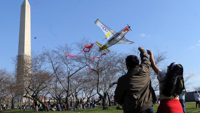 People fly kites near the Washington Monument on March 30, 2013 during the annual Blossom Kite Festival in Washington, DC. Th