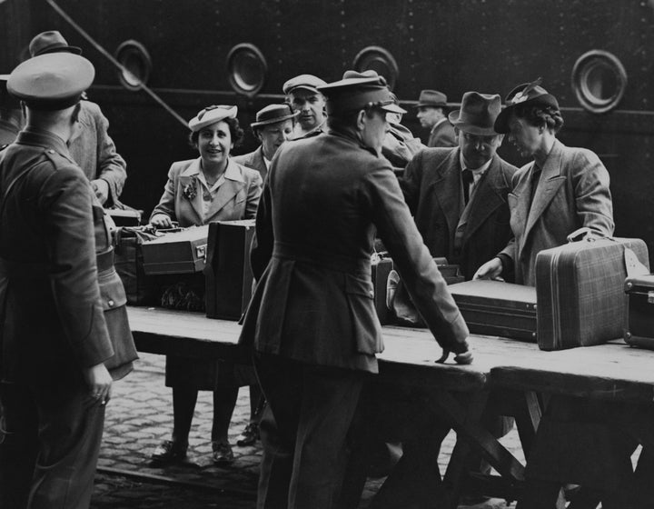 Refugees go through customs on arrival in Antwerp onboard the MS St. Louis, after over a month at sea, during which they were