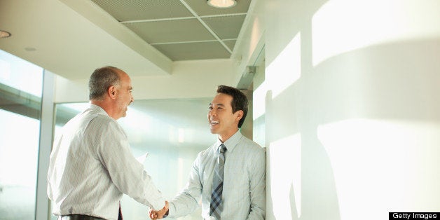 Smiling businessmen talking in office