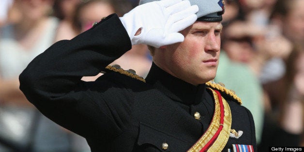 ARLINGTON, VA - MAY 10: HRH Prince Harry wearing his No. 1 ceremonial uniform of The Blues and Royals salutes as he pays his respects to the victims of the Afghanistan conflict and the tomb of the unknown soldier during the second day of his visit to the United States at Arlington National Cemetery on May 10, 2013 in Arlington, Virginia. HRH will be undertaking engagements on behalf of charities with which the Prince is closely associated on behalf also of HM Government, with a central theme of supporting injured service personnel from the UK and US forces. (Photo by Chris Jackson/Getty Images)