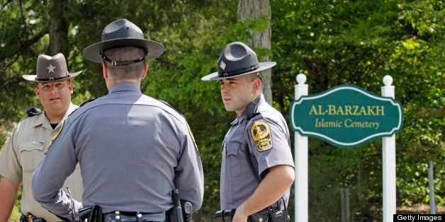 DOSWELL, VA - MAY 10: Police stand in front of a sign at Al-Barzakh Islamic Cemetery May 10, 2013 in Doswell, Virginia. Boston Marathon bombing suspect Tamerlan Tsarnaev is allegedly is buried in the cemetery and the owner of the cemetery did not want to confirm which grave holds the body of Tsarnaev. (Photo by Jay Paul/Getty Images)