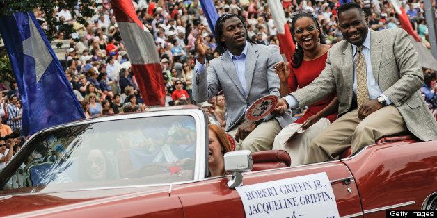 WASHINGTON, DC - MAY 27: Robert Griffin III, Jacqueline Griffin and Robert Griffin Jr ride inthe 2013 Memorial Day Parade at Constitution Avenue on May 27, 2013 in Washington, DC. (Photo by Kris Connor/Getty Images)