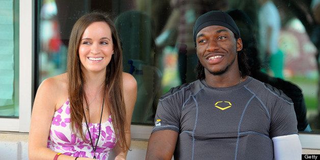 ASHBURN VA JULY 30: Rebecca Liddicoat, left, sits with her fiance, Washington Redskins' rookie quarterback Robert Griffin III after the 4th day of training camp at Redskins Park in Ashburn VA July 30 2012 (Photo by John McDonnell/The Washington Post via Getty Images)